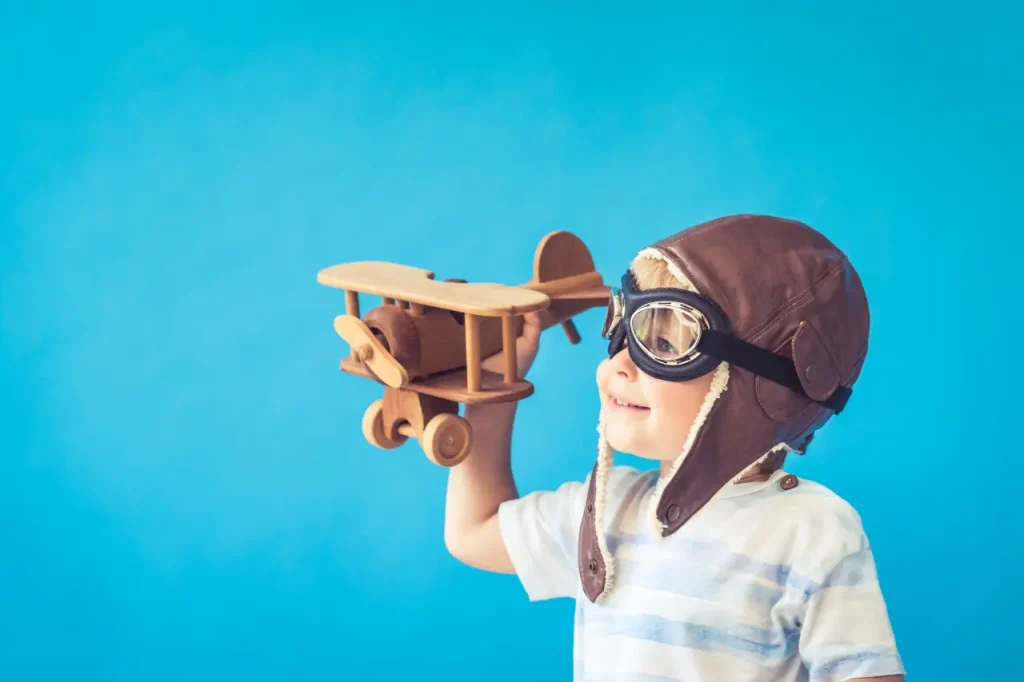 Children enjoying creative play activities with aeroplane at Funky Nursery & Pre-School in Cheltenham
