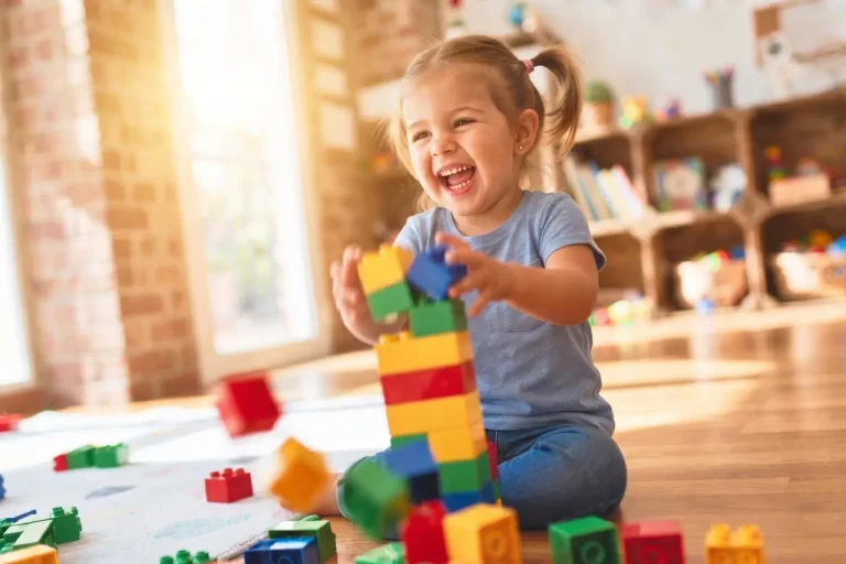 Toddler building with colourful blocks in the Toddler Room at Funky Nursery in Cheltenham
